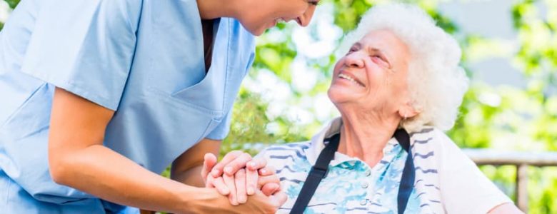 caregiver holding hand of senior woman